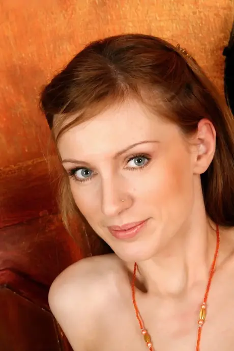 Olga Bars, an amateur, poses wearing only heels and displays her trimmed pussy