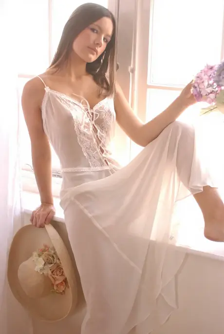 Naked long-haired solo model displays her firm breasts and tight rear