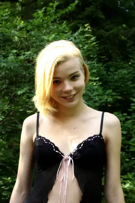 Platinum blonde sweetheart Sophia Kitten rubs her shaved pussy outdoors