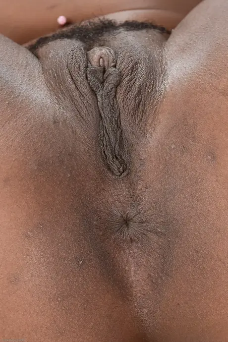 Charlie Rae, ebony teen, grips her bare ass and reveals her pink pussy