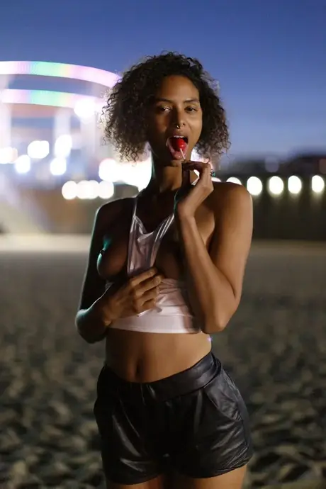 Petite ebony Desiree Jacobsen reveals her small breasts and round ass in a solo