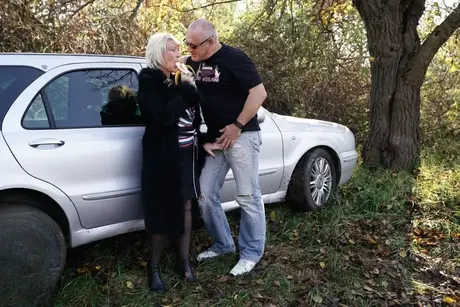 Moden blond kvinde spiser en banan før en gangbang på landet
