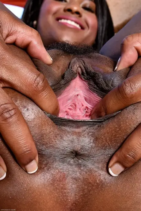Charlie Rae, a Black woman, spreads her pussy lips to reveal the pink interior