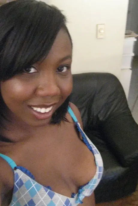Elisha, the ebony beauty, captures self-portraits as she undresses to reveal her breasts