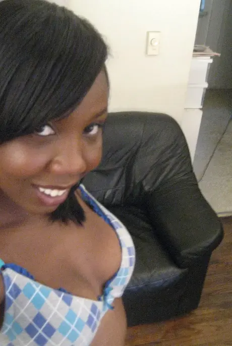 Elisha, the ebony beauty, captures self-portraits as she undresses to reveal her breasts