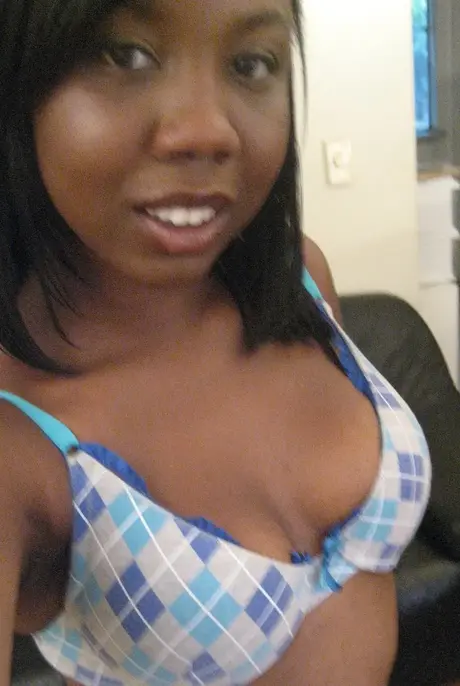 Elisha, the ebony beauty, captures self-portraits as she undresses to reveal her breasts