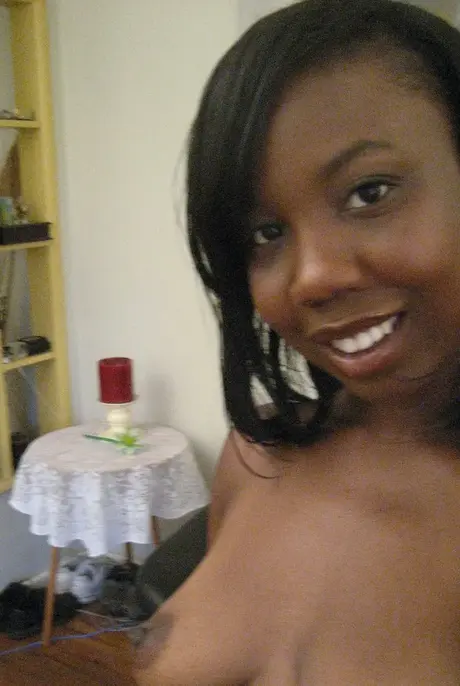 Elisha, the ebony beauty, captures self-portraits as she undresses to reveal her breasts