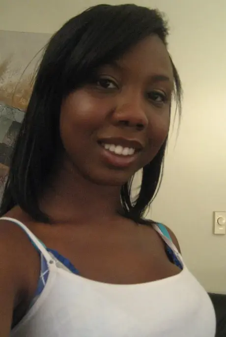 Elisha, the ebony beauty, captures self-portraits as she undresses to reveal her breasts