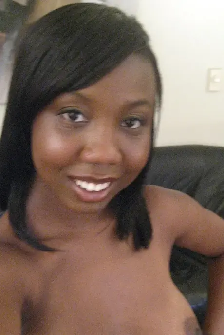 Elisha, the ebony beauty, captures self-portraits as she undresses to reveal her breasts