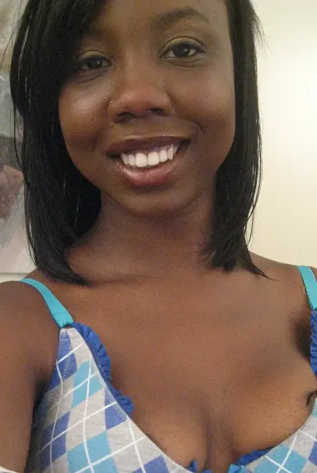 Elisha, the ebony beauty, captures self-portraits as she undresses to reveal her breasts