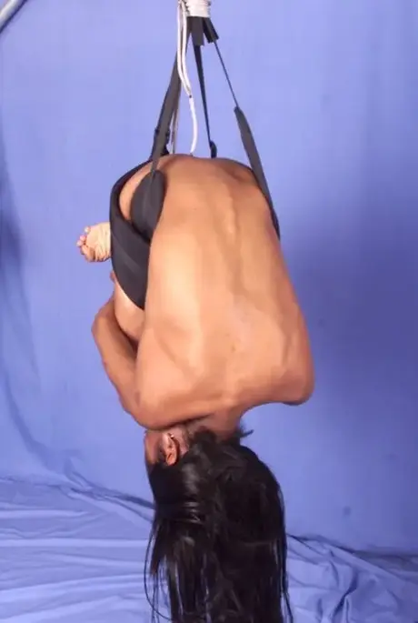 Tierra, an ebony beauty, is suspended by her waist and spanked