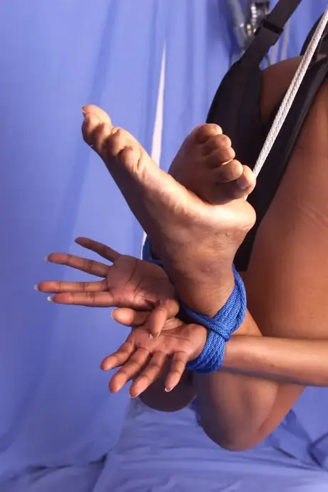 Tierra, an ebony beauty, is suspended by her waist and spanked