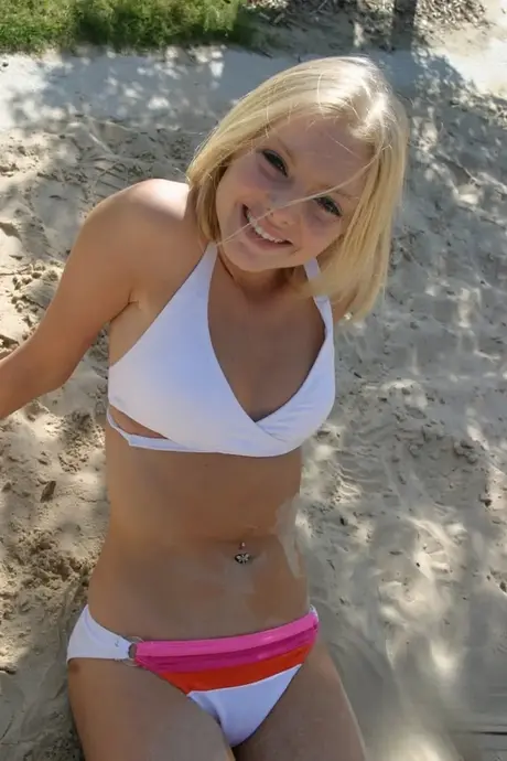Skye Model em um biquíni branco sexy e chinelos na praia
